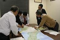 Officials from the JWWA discuss strategy <BR>for assisting areas impacted by the earthquake and tsunami.<BR> Strategy meeting at JWWA headquarters begin <BR>at least every two hours.